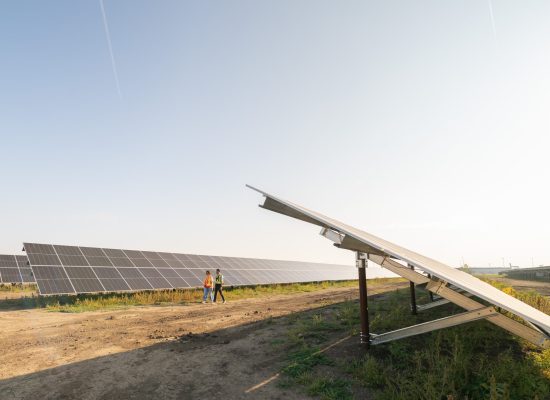 solar panels with 2 people walking along side them